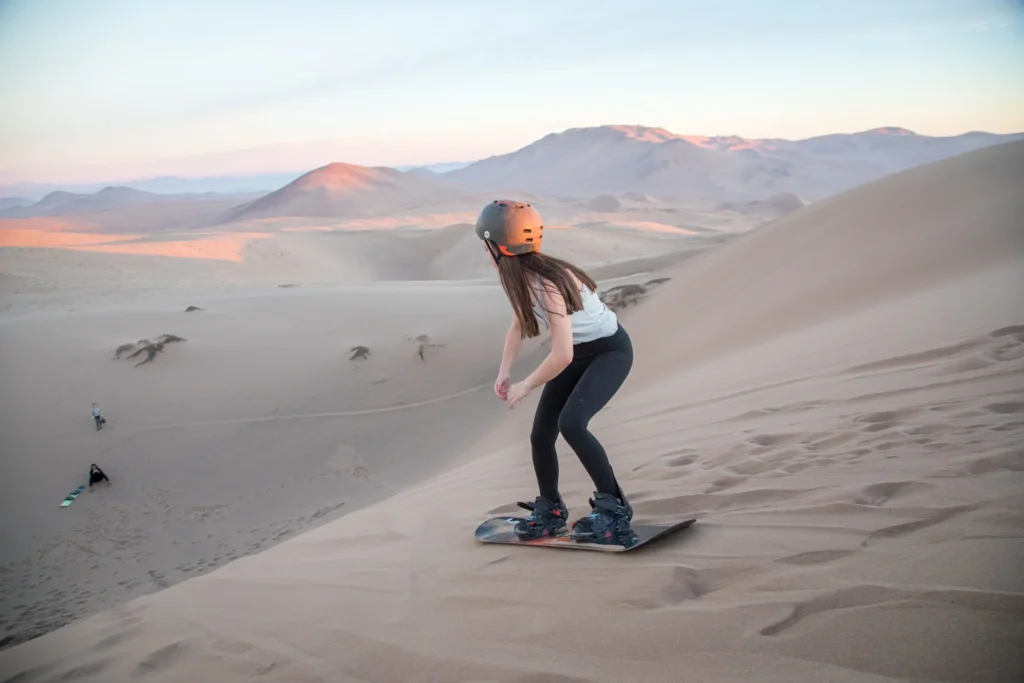 Kid sandboarding in the Atacama Desert, Chile