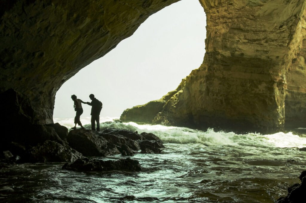 Couple in the inside of a cave in Ballestas Grotto, Peru Private Custom Luxury Travel