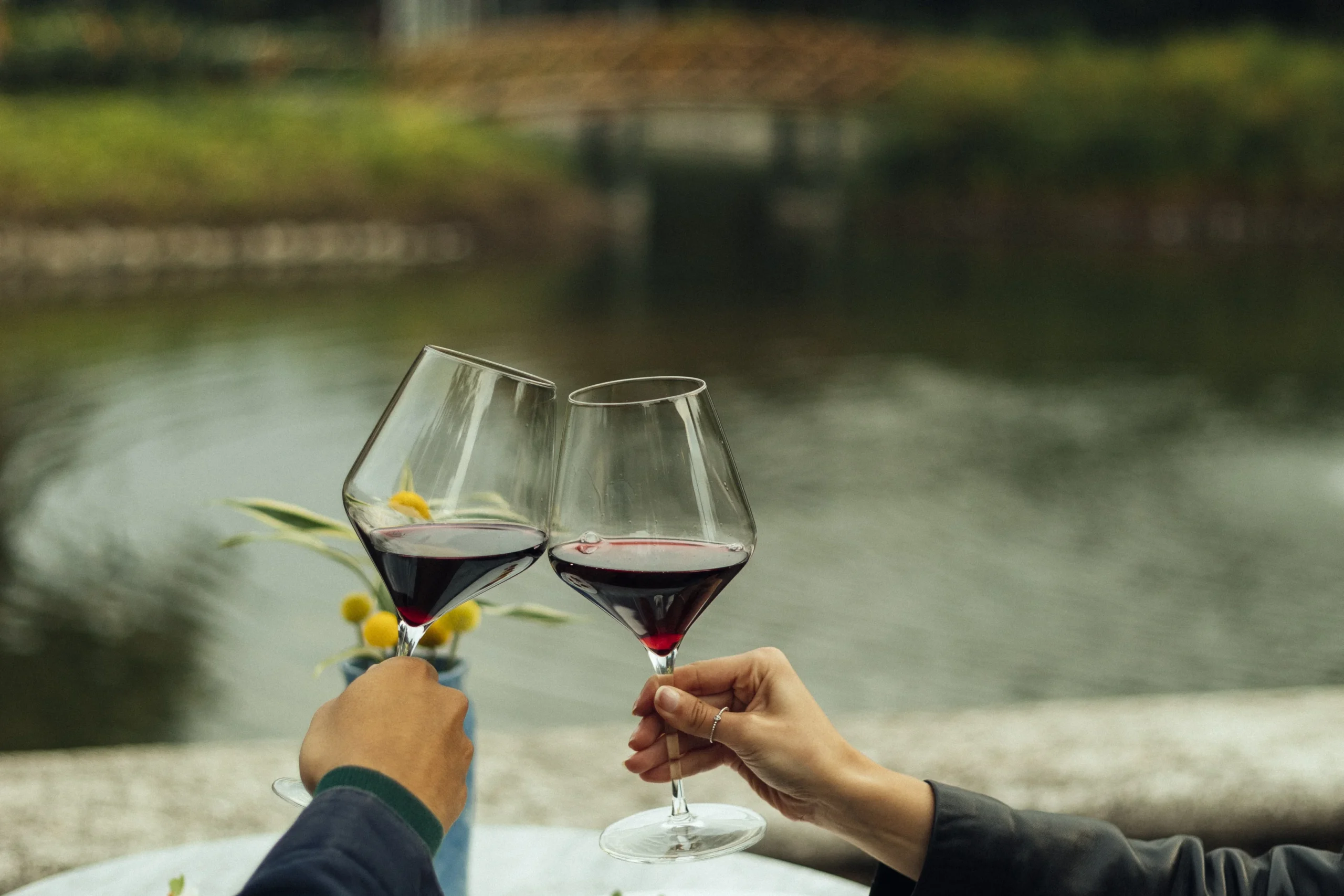 Couple enjoying a glass of wine in Villa Bokeh manicured gardens beneath three volcanoes in Antigua Guatemala
