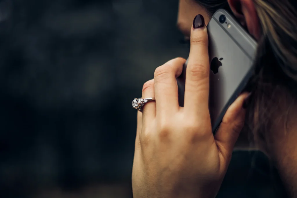a woman holds a cell phone during a phone call
