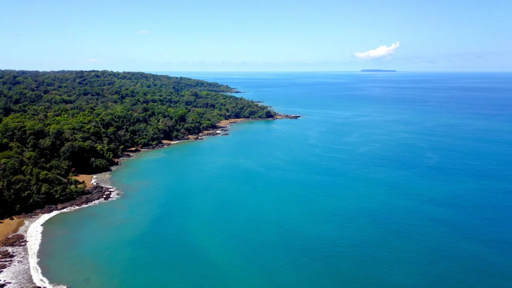 Aerial drone view of the remote, forested coastline and turquoise waters of the Osa Peninsula in Costa Rica.