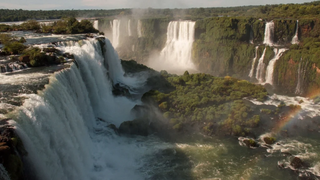 Rushing water and a subtle rainbow at the dramatic Devil's Throat canyon section of Iguazu Falls.